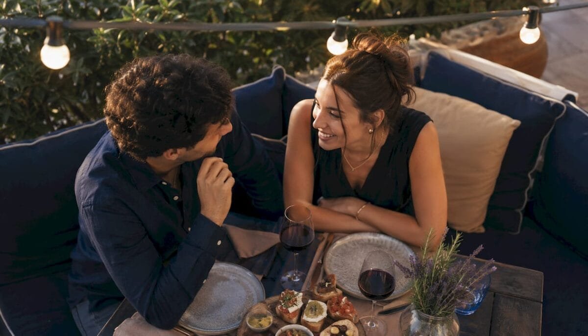 Couple enjoying romantic candlelit dinner at home