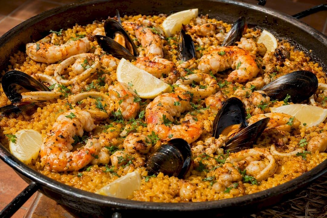 Seafood paella with shellfish close-up top view
